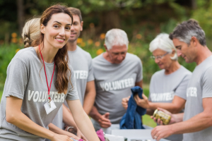 Happy volunteer looking at donation box on a sunny day