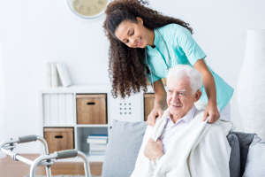 Young African American doctor helping senior man